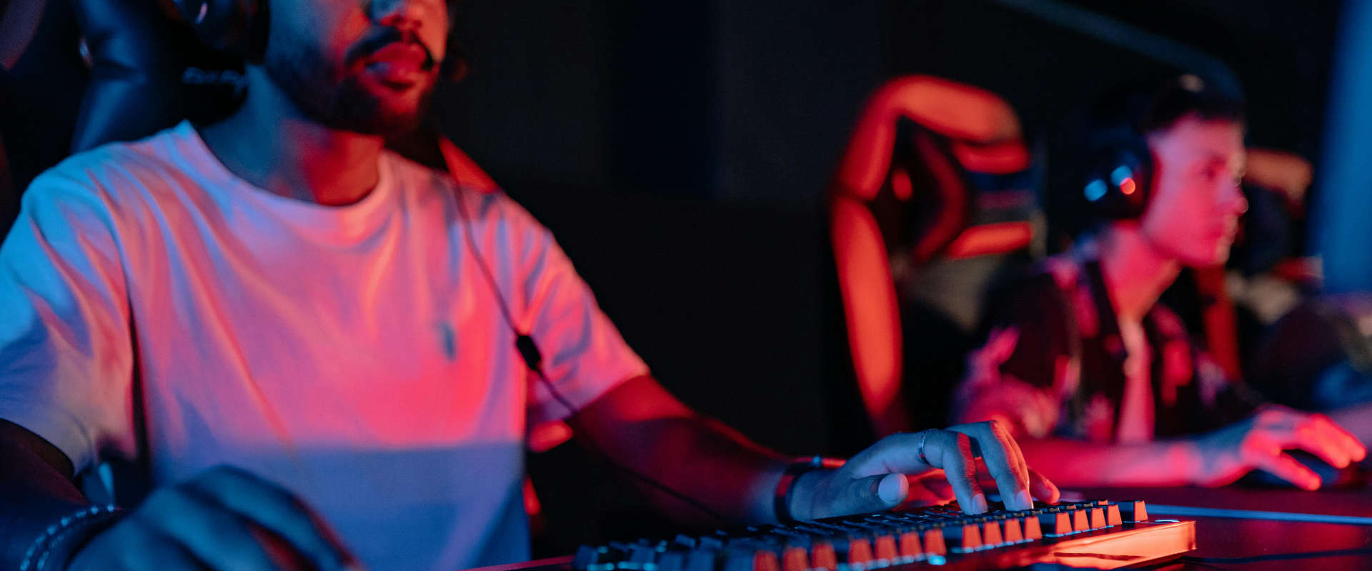 a man in a white shirt gaming on a computer